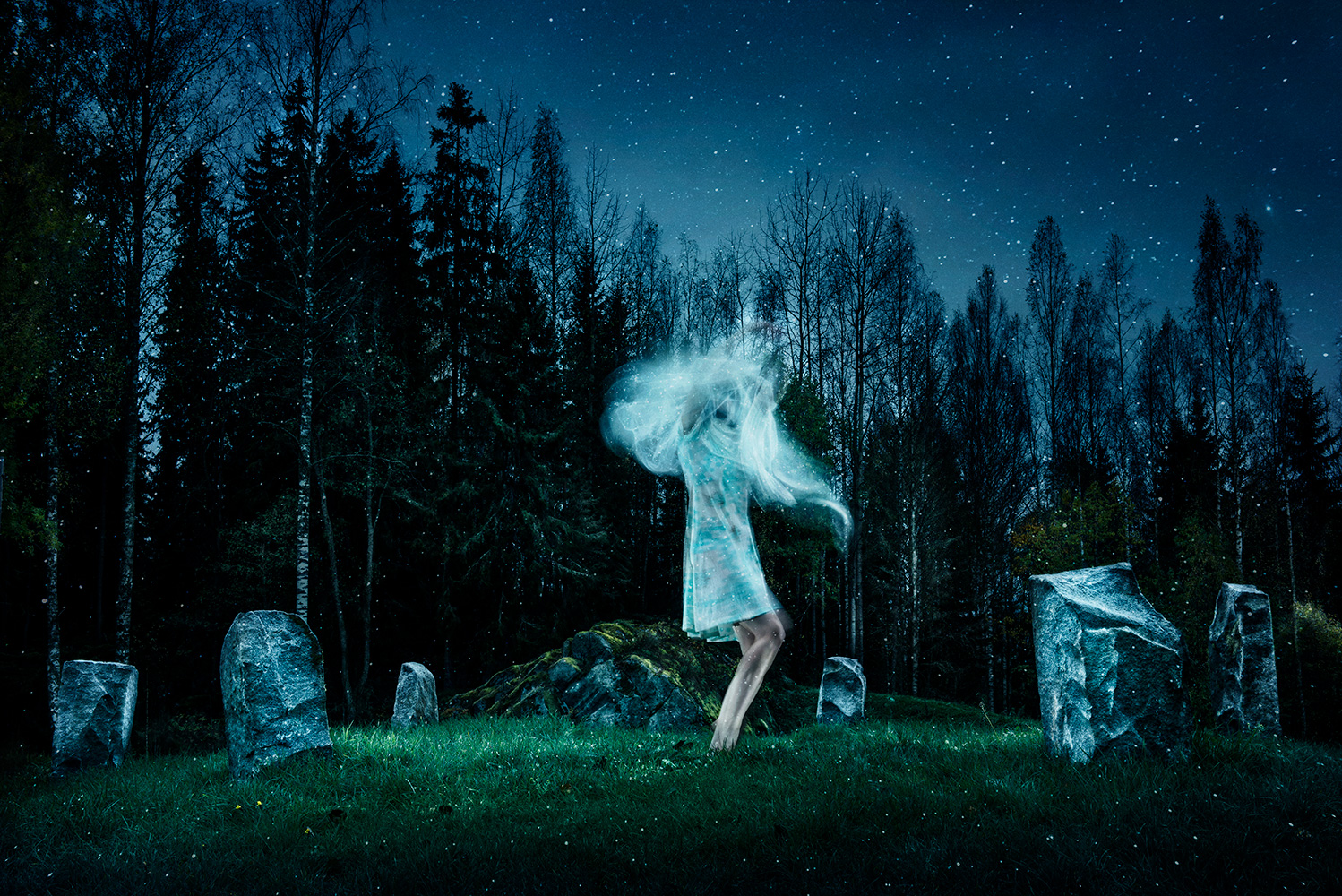 Conceptual fine art photography cinematic tableaux of female figure dancing in stone circle using long exposure photographic technique to create feeling of soul escaping body by Johannesburg photographer Natalie Field in Finalnd at the Arteles Creative Center
