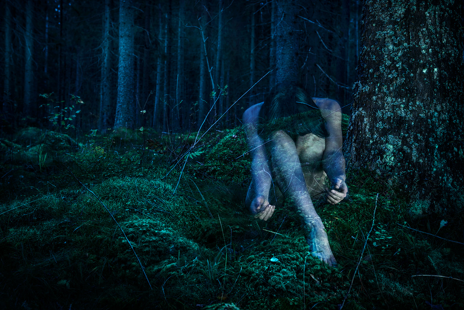 Conceptual fine art photography cinematic tableaux of female figure fading into the woods using double exposure and self-portraiture by contemporary and artist photographer Natalie Field