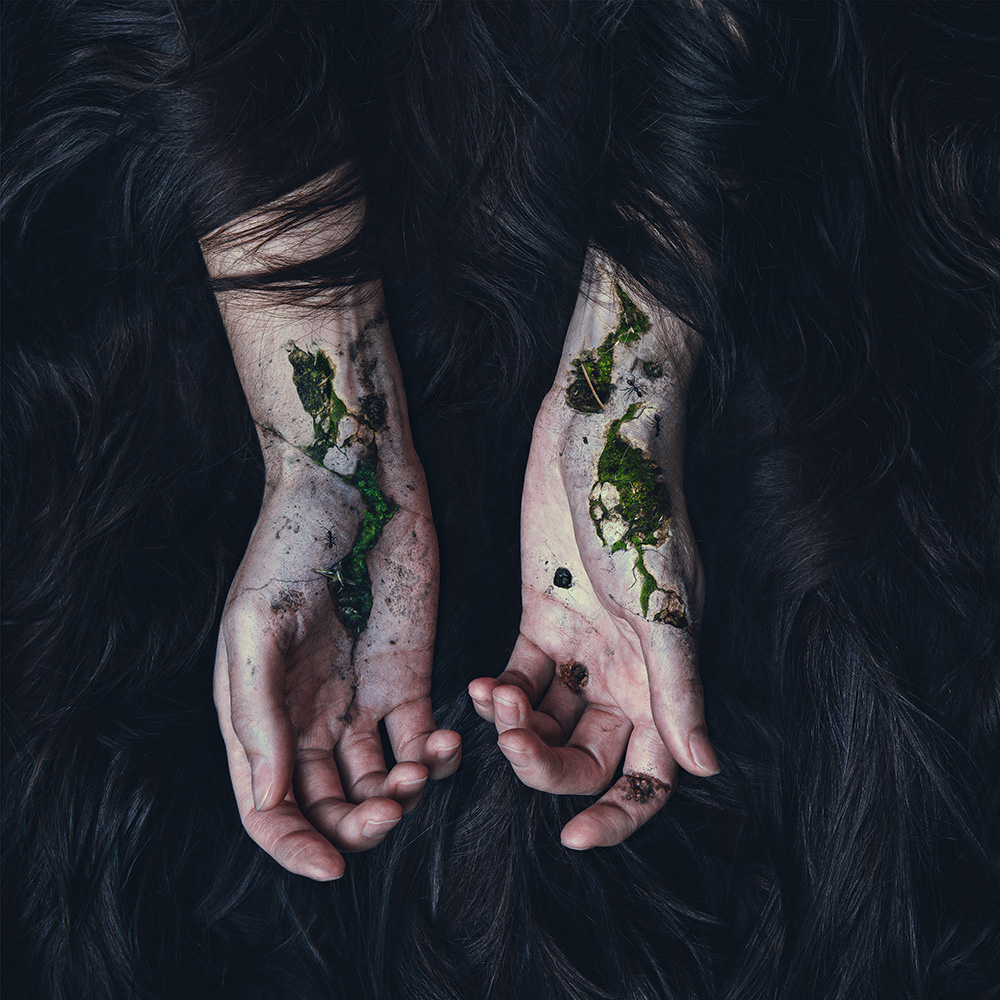 Self-portraiture of human body with nature pushing through from beneath the skin created by digital artist and bio surrealistNatalie Field